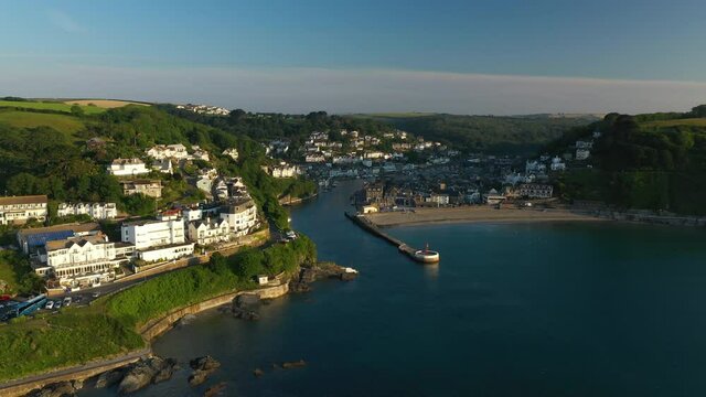 4K: Aerial Drone Video of Looe in Cornwall, England, UK. Flying high up around the Coastline of the town. Banjo Pier. Stock Video Clip Footage