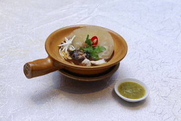 double boiled luxury seafood shark's fin crab meat and mushroom thick soup in hot clay pot asian premium halal menu