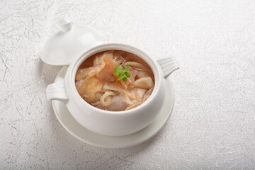 double boiled luxury seafood shark's fin crab meat and mushroom thick soup in hot clay pot asian...
