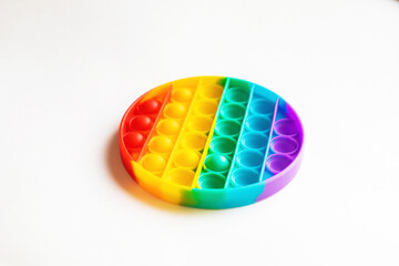 Girl plays Popit. Silicone Anti-stress Sensory Toy. Trend 2021. Pop It is a Colorful, Simple Dimple Reusable Stress Relief Toy.