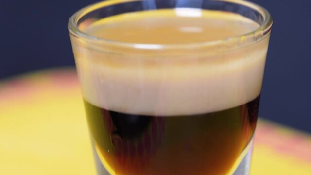 Closeup Of A Shot Glass With Layered Cocktail B52 At The Bar Counter.