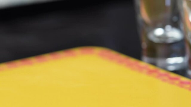Female Hand Picks Up A B52 Shot Glass Or Cocktail Drink On The Table. closeup