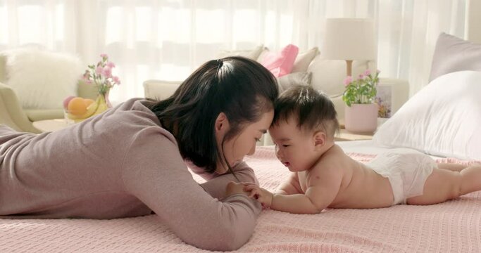 Young mom taking care of baby girl,4K