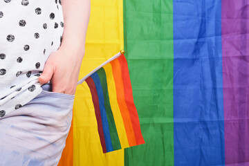 Rainbow LGBT flag in the back pocket of jeans, concept of gender equality.