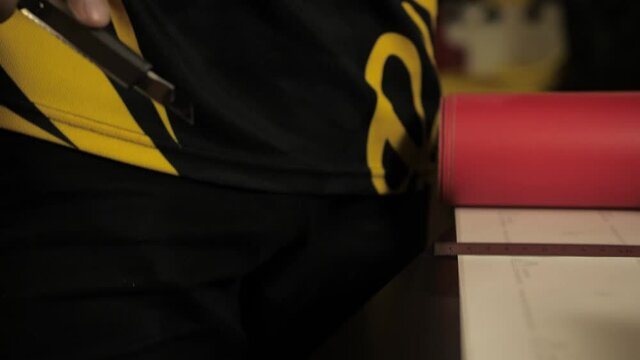 Man cutting vinyl. Car wrap