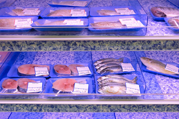 Low selection of pre packed fresh raw fish displayed on shelves for sale in supermarket. Due to recent covid-19 cluster in fishery port, fresh seafood is in short supply