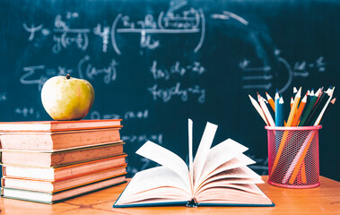 Pencils and book and blackboard. Education concept.
