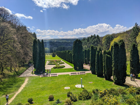 Kislovodsk, Russia - May 1, 2021: People walk in the large Kislovodsk National Park. People admire the green cypress avenue and the flowers of the Rose Valley.