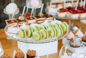 Candy bar. Beautiful multi colored decorated candy table baked sweet tasty cupcake cupcakes on a party. Beautifully decorated catering banquet table with different candy sweet delicacy.