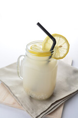 cold iced lemon barley juice with lemon in glass jar white background asian beverage halal menu