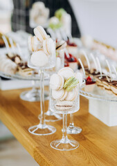 French macaroons in a glass stand . Candy bar on wedding.