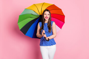 Photo of young cheerful woman happy positive smile hold colorful umbrella rain isolated over pastel...