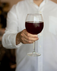 Man hand glass of red wine for health benefits
