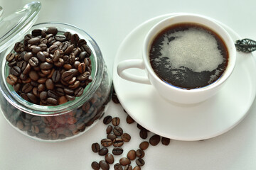 cup of black coffee and coffee beans.