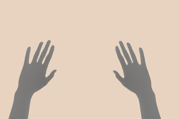 Abstract image of the pair of hand shadows on the pastel  beige background.