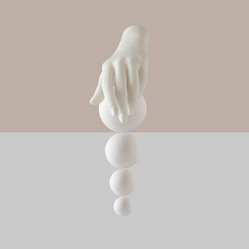 Creative arrangement with artificcial hand and white balls over pastel beige and white  background.