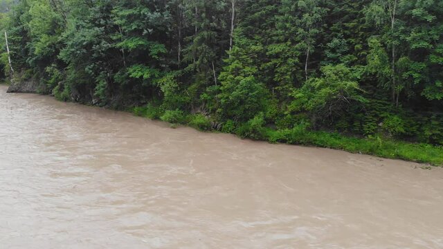 Mountain river after heavy rains. The water in the river is dirty from soil and stones. This situation is the forerunner of flooding in Europe.