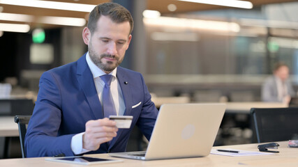 Fototapeta premium Successful Online Payment on Laptop by Middle Aged Businessman