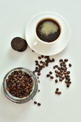 cup of black coffee and coffee beans, a piece of chocolate