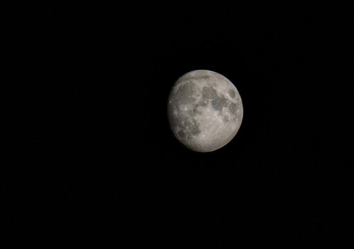 The moon is almost full. Photographed at night - dark background.