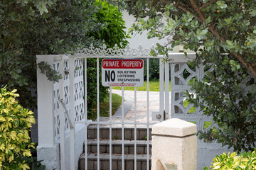 Private property sign on a white gate in Deerfield Beach, Florida