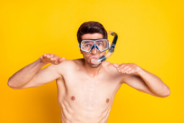 Photo of funky brunet young guy swim wear mask isolated on yellow color background