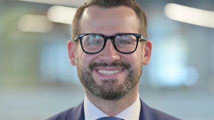 Fototapeta premium Close up of Middle Aged Businessman Smiling at Camera