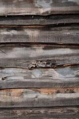 Old fence made of uneven horizontally placed boards. Wood planks texture.