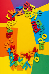 English alphabet on a multicolored background top view. Space for copying text. Back to school. Vertical photo