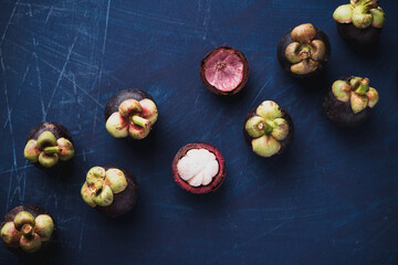 Mangosteen fruit on blue color background, Flat lay, Tropical fruit