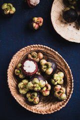 Mangosteen fruit in basket on blue color background, Tropical fruit