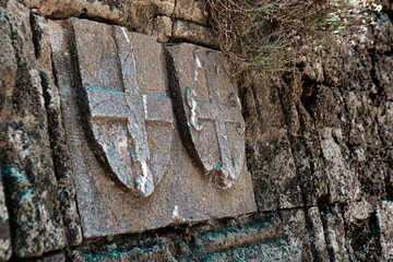 Medieval heraldica on castle stone walls, stone caving, cultural heritage, armorial details