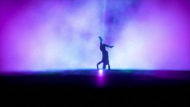 Breakdancer dancing on a stage against colorful spotlights, slow motion, Luma Matte