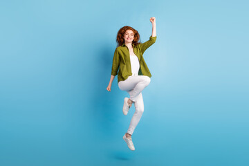 Full length body size view of attractive slim fit lucky cheerful girl jumping striving isolated over pastel blue color background