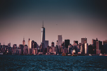 Fototapeta na wymiar New York City Manhattan downtown skyline at dusk with skyscrapers illuminated over Hudson River panorama.
