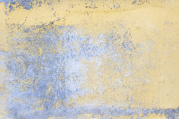 Old gray blue wall texture with peeling yellow paint background. Closeup.