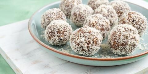 Home made energy protein balls with coconut flakes and nut butter, banner
