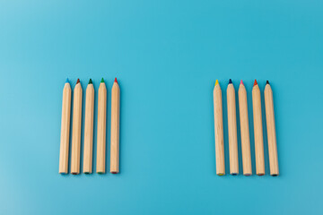 Wooden colorful ordinary pencils isolated on blue background