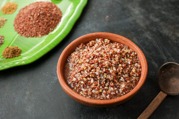 Ayurvedic porridge, Karkidaka Kanji herbal gruel in clay pot black background Kerala South India....