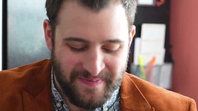 Handsome Man With Bearded Face Drinks A Shot While Concealing the Glass With His Hand At The Bar. closeup