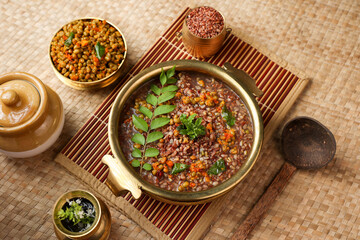 Ayurvedic porridge, Karkidaka Kanji herbal gruel in brass golden bowl Kerala South India. Ayurveda diet health drink for immunity, cleanse the body. Top view medicinal rice porridge Indian veg food