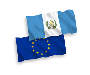 National vector fabric wave flags of European Union and Republic of Guatemala isolated on white background. 1 to 2 proportion.