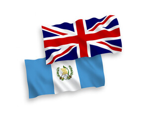 National vector fabric wave flags of Great Britain and Republic of Guatemala isolated on white background. 1 to 2 proportion.