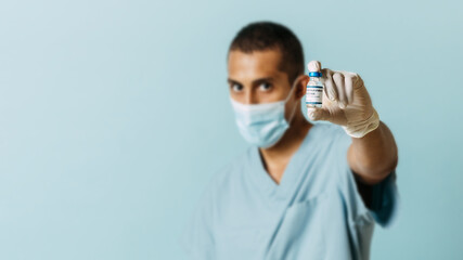 unfocused man holding coronavirus vaccine. pandemic and health concept.