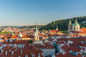 View to Prague red roofs from castle at summer morning