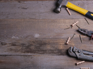 Set of hand tools for repair top view on a wooden background. Repair of items