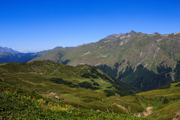 Fototapeta premium view of The Main Caucasian Ridge with rocky mountains and alpine meadows