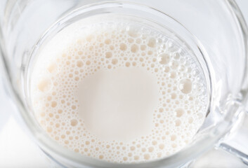 Milk in a glass, Image on top view. Isolated on white background.