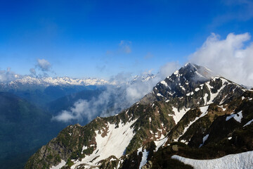 mountain peak with snow and clouds in caucasus mountains