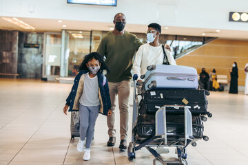 Family in face masks at airport